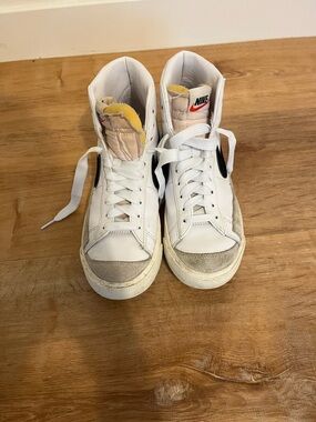 Nike White High-Top Sneakers with Black Swoosh